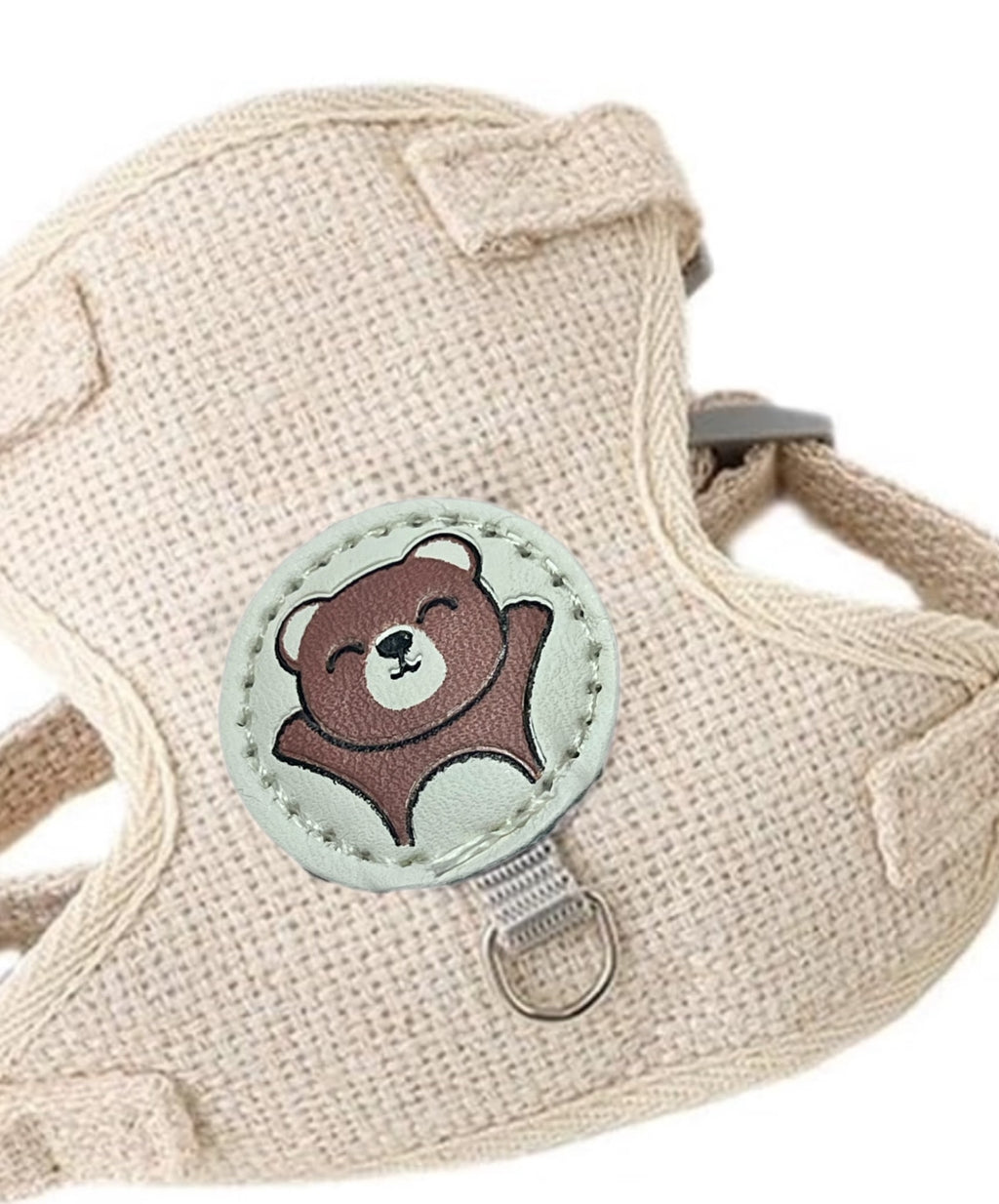 Beige dog harness with a bear-shaped patch on a white background